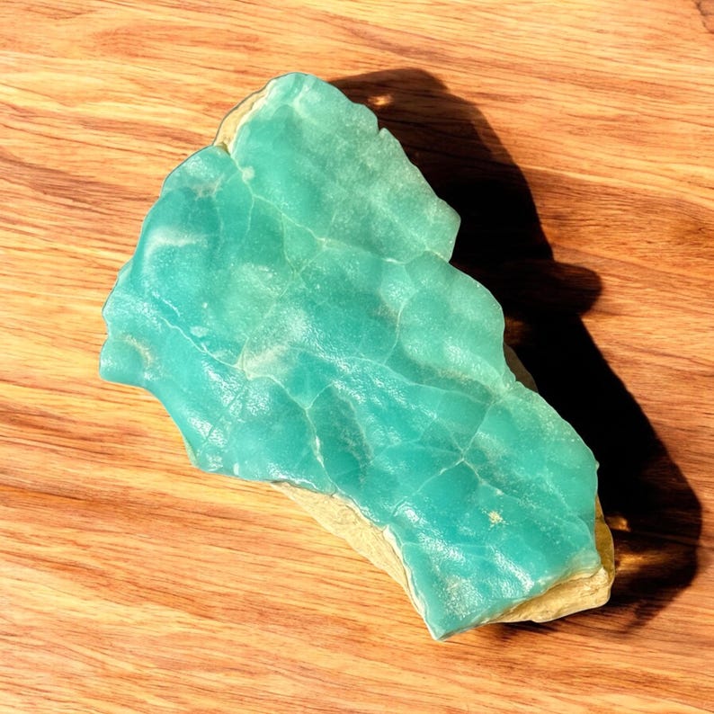 High quality Blue Aragonite on matrix specimen from Crazy Ohio Crystals, weighing 150 grams and measuring 3.5 inches wide, showcasing vibrant aqua-blue crystals on natural earthy base.