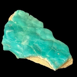 High quality Blue Aragonite on matrix specimen from Crazy Ohio Crystals, weighing 150 grams and measuring 3.5 inches wide, showcasing vibrant aqua-blue crystals on natural earthy base.