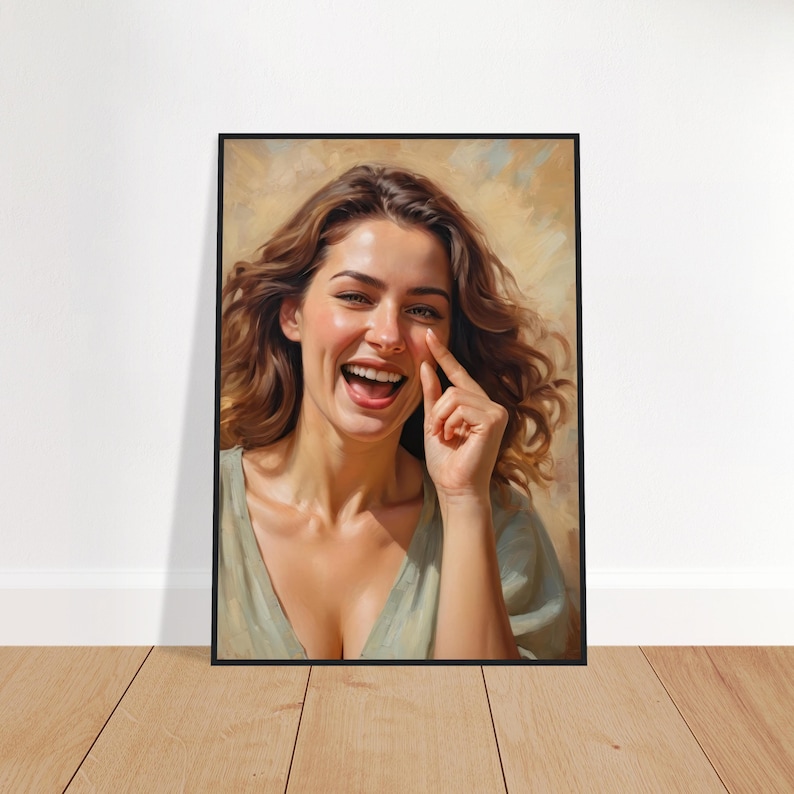 May include: A woman with long brown hair is laughing and touching her nose with her finger. She is wearing a light green top and has a warm, natural background.