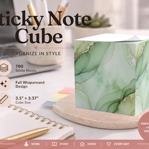 May include: A square sticky note cube featuring a green and white marble-like alcohol ink pattern with gold accents. The cube contains 700 sheets, measures 3.5 inches by 3.37 inches, and displays a full wraparound design on all visible sides.