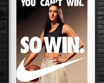 May include: A framed Nike advertisement featuring a woman in a black sports bra and khaki pants holding a basketball. The text reads "YOU CAN'T WIN. SO WIN." The Nike swoosh logo is prominent, with the names "CAITLIN CLARK" below.