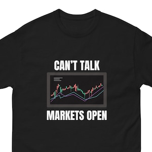 May include: Black t-shirt with a white graphic of a stock market chart and the text "Can't Talk Markets Open".