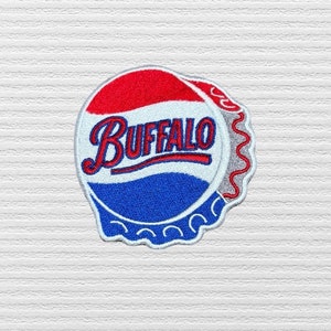 May include: A red, white, and blue embroidered patch shaped like a bottle cap with the word "BUFFALO" in a white cursive font.