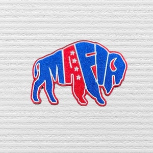 May include: A blue and red buffalo silhouette with the word "MAFIA" written across it. The buffalo has five stars on its back.