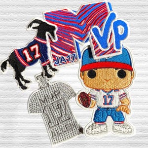 May include: Four embroidered patches featuring a goat wearing a blue and red jersey with the number 17, a football player wearing a blue and red jersey with the number 17, a white and red striped patch with the letters MVP, and a gray patch with the letters MVP.