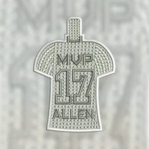 May include: A gray embroidered patch shaped like a jersey with the text "MVP 17 ALLEN" on it.