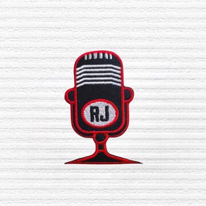 May include: Embroidered patch featuring a vintage-style microphone design. The microphone is black with white horizontal lines and a red outline. The letters "RJ" are inside a white oval. The patch has a red base.