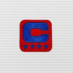 May include: Red and blue embroidered patch with a large capital "C" and five stars.