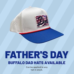 May include: A white and blue baseball cap with the word "Dad" embroidered on a patch. The cap has a red brim and a blue bill. The text "FATHER'S DAY" and "BUFFALO DAD HATS AVAILABLE" are also visible.
