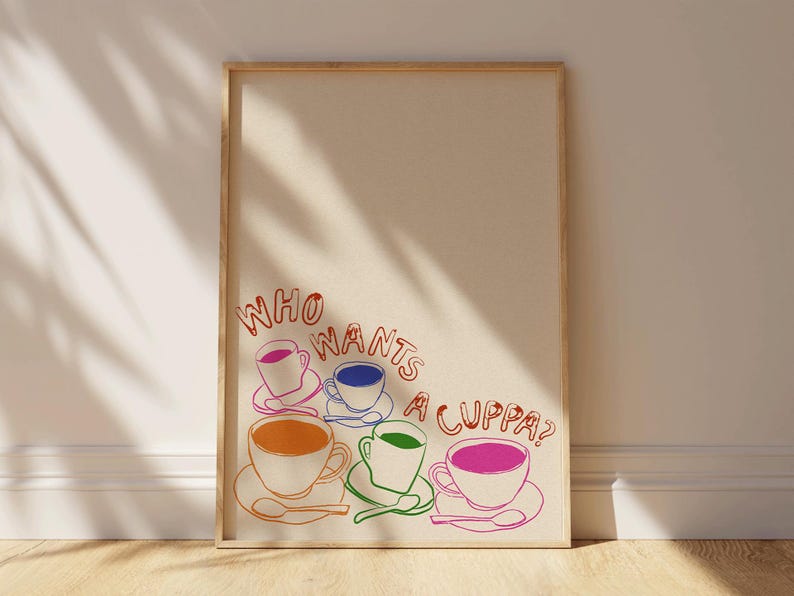 May include: A framed print with the text "Who wants a cuppa?" in red and orange. Five colorful teacups are arranged in a semi-circle below the text.
