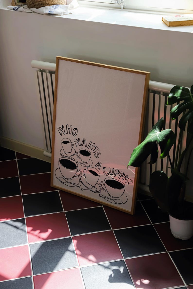 May include: A framed print with a black and white illustration of five teacups and the text "Who wants a cuppa?"