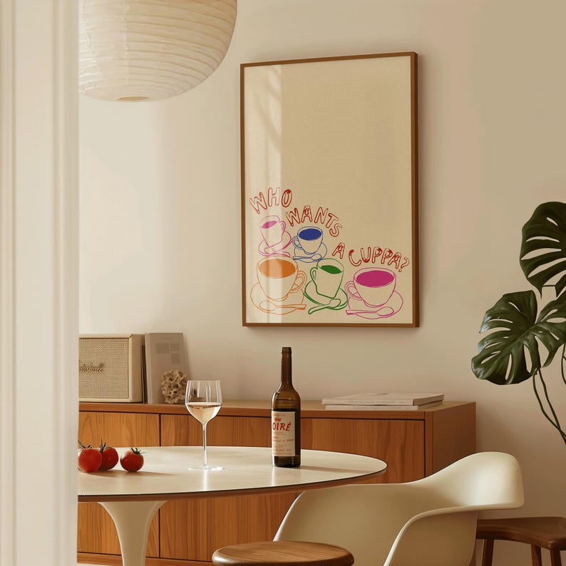 May include: A framed print with a white background and colorful text that reads "Who wants a cuppa?" with a drawing of five teacups in different colors.