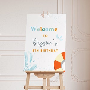 Könnte beinhalten: Willkommen zum 8. Geburtstag von Bryson Schild mit einem blauen und orangefarbenen Rettungsring und einem Wasserspritzendesign.