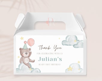 May include: White favor box with a thank you tag featuring a cartoon bear with a pink balloon, clouds, and stars. The tag says "Thank You for celebrating with us Julian's Beary First Birthday".