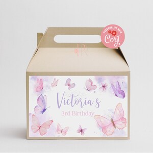 May include: A tan party favor box with a handle, featuring a watercolor design of pink and purple butterflies. The box is decorated with the text "Victoria's 3rd Birthday". A pink sticker on top says "Personalize with Cori!"