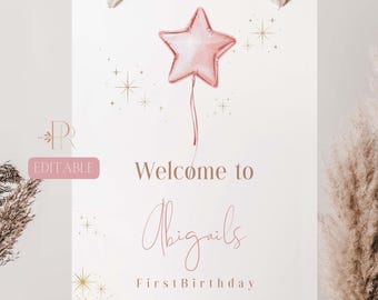 May include: A printable welcome sign for a first birthday party. The sign features a pink star balloon with gold glitter stars and the text "Welcome to Abigails First Birthday".