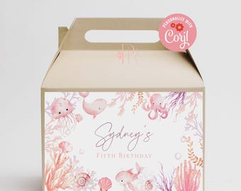 May include: A brown cardboard favor box with a handle. The box has a white label with a pink and purple watercolor design of sea creatures, coral, and seashells. The text on the label reads "Sydney's Fifth Birthday".