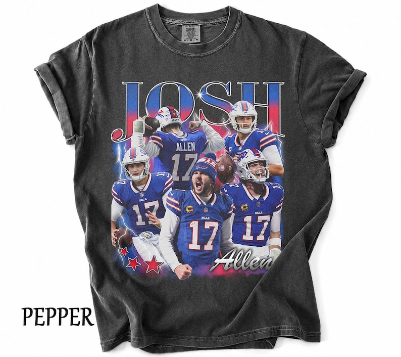 May include: A charcoal gray short-sleeve t-shirt featuring a graphic print of football player Josh Allen in various action poses wearing a blue Buffalo Bills uniform. The text JOSH and Allen appear in large stylized lettering with blue lightning.