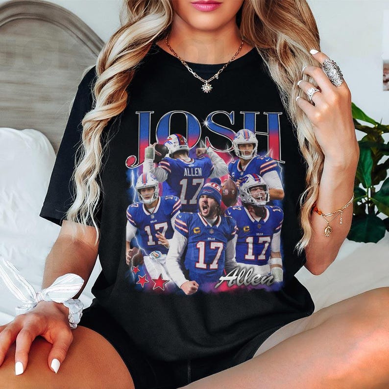 May include: A black short-sleeve t-shirt featuring a graphic print of American football player Josh Allen in various poses wearing a blue and red uniform with the number 17. The text JOSH and Allen are printed in a bold, vintage-style font.
