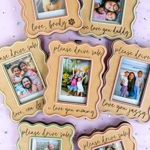May include: Six wooden photo frames with a wavy border and a light brown finish. Each frame has a different photo and a personalized message. The messages include "love, brody", "we love you daddy", "please drive safe", "love, com & d", "i love you mommy", and "love you jazzy".