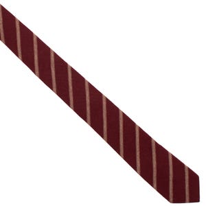 May include: A burgundy striped tie with thin, light brown stripes.