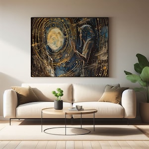 May include: A large framed canvas art print depicting an Egyptian pharaoh with a blue and gold headdress, set against a backdrop of swirling gold and blue celestial patterns. The artwork is displayed above a cream-colored sofa.