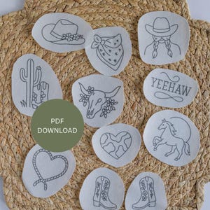 May include: A collection of embroidered patches with a Western theme. Designs include a cowboy hat, bandana, cactus, bull skull, heart, horse, boots, and the word "Yeehaw". The patches are on a woven straw background.