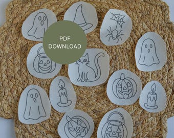 May include: A collection of Halloween-themed fabric patches with embroidered designs. The patches include a ghost, witch hat, spider with web, jack-o'-lanterns, a black cat, and candles. The text "PDF DOWNLOAD" is in the center. The patches are arranged on a woven mat.