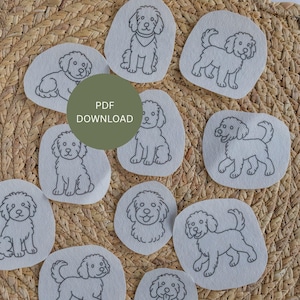 May include: A collection of embroidered dog patches in various poses, outlined in gray on a light fabric. The patches are arranged on a woven, tan surface. A green circle in the center reads "PDF DOWNLOAD".