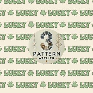 May include: A repeating pattern of the word "LUCKY" in light green with shamrock symbols on a cream background. A circular emblem features the number "3" and the words "PATTERN ATELIER".
