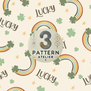 May include: A cream-coloured pattern featuring rainbows, shamrocks, and stars. The word "LUCKY" is written in a whimsical font. A circular emblem in the centre reads "3 PATTERN ATELIER". The design has a vintage, St. Patrick's Day theme.