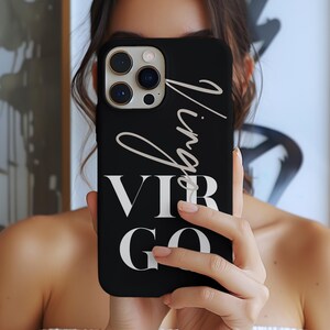 May include: Black phone case with the word "Virgo" in a white script font and the letters "VIR GO" in a bold, white sans-serif font. The case has a camera module with three lenses.