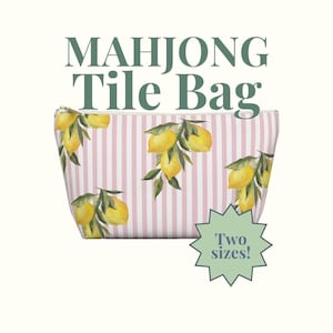 May include: A Mahjong Tile Bag with a pink and white striped pattern, adorned with yellow lemon illustrations. The bag has a zipper closure and the text "Two sizes!" is displayed on the image.