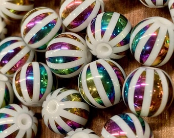 May include: A collection of white, spherical beads with iridescent, rainbow-colored stripes. The beads have a glossy finish and are designed with a hole for stringing. The stripes reflect a spectrum of colors, including gold, green, and purple.