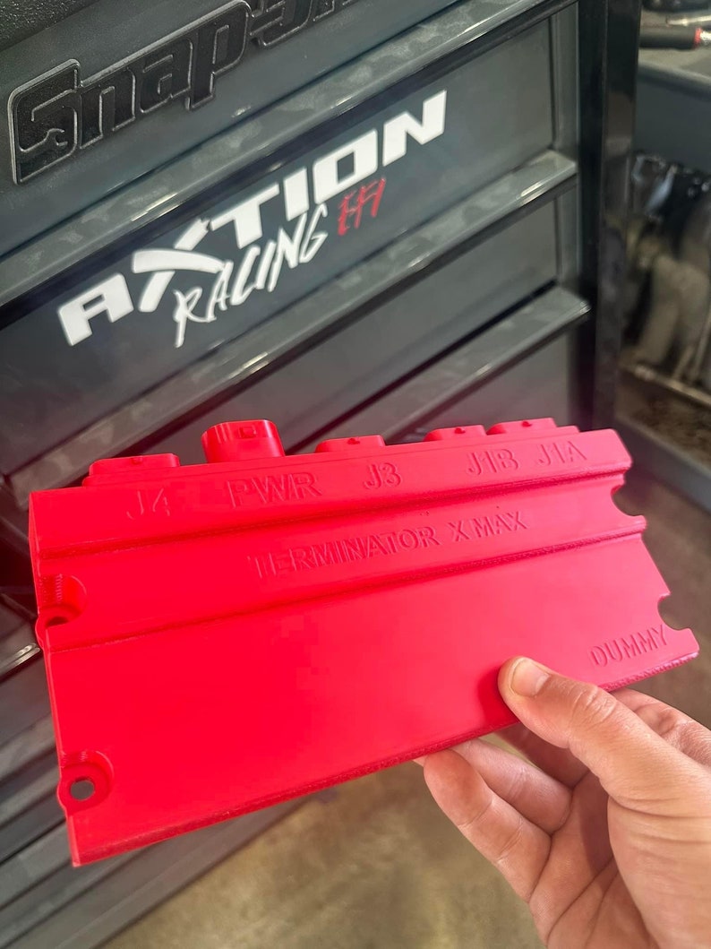 May include: Red plastic connector with the text "TERMINATOR X-MAX" and labels "J4", "PWR", "J3", "J1B", "J1A", and "DUMMY".