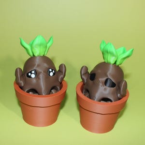 May include: Two brown, cartoon-like figures with green leafy tops sit in terracotta-colored pots. The figures have small arms and white and black eyes. The background is a solid, light green color.