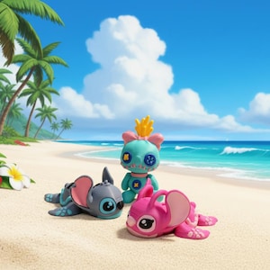 May include: Three cartoon character figurines on a sandy beach with palm trees and ocean in the background. One figurine is teal with a yellow crown, and the other two are gray and pink, all with large eyes and ears.