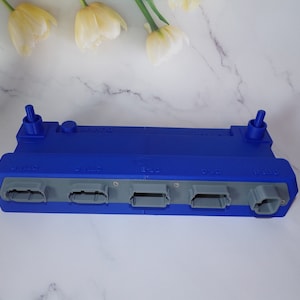 May include: A blue plastic connector with five ports labeled "5-W", "5-W", "5-W", "5-W", and "5-W".