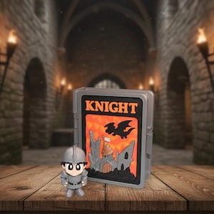 May include: A gray plastic case with the word "KNIGHT" in orange letters, a castle, and a dragon graphic. A small knight figurine in gray armor stands in front of the case. The background is a medieval castle interior.