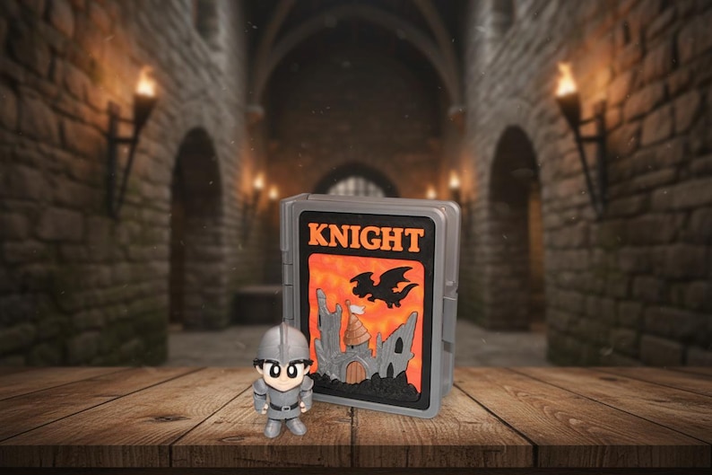 May include: A gray plastic case with the word "KNIGHT" in orange letters, a castle, and a dragon graphic. A small knight figurine in gray armor stands in front of the case. The background is a medieval castle interior.