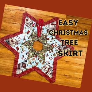 May include: A star-shaped Christmas tree skirt with a red border and a festive pattern of houses and snowmen. The text "EASY CHRISTMAS TREE SKIRT" is displayed on the image.