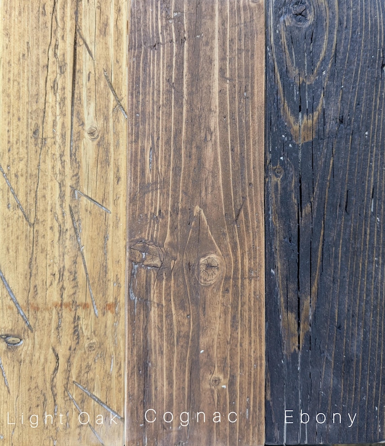 May include: Three vertical wooden planks showing distinct wood grain and texture. The left plank is light oak, the center is cognac brown, and the right is ebony black. Each plank is labeled at the bottom with the text Light Oak, Cognac, and Ebony.