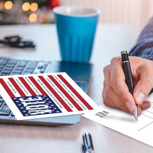 May include: A postcard with a red, white, and blue American flag design. The text on the postcard reads "Vote" in large, bold letters. The text below the flag reads "People & the Planet are valued over profit", "Women are in charge of their bodies", "Immigrants & Refugees are welcome", "Diversity is celebrated", "Black Lives Matter", and "Vote in our America".