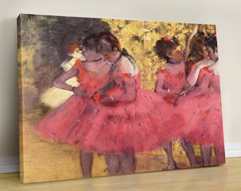 May include: Canvas print of a Degas painting featuring ballerinas in pink tutus. The artwork depicts several dancers in a rehearsal or performance setting, with a golden-hued background. The ballerinas are the focal point, with their pink dresses and graceful poses.