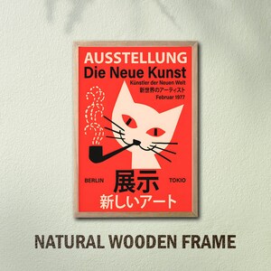 May include: A red and white poster with a cat smoking a pipe. The poster is framed in natural wood and has the text "AUSSTELLUNG Die Neue Kunst" in German and "展示 新しいアート" in Japanese. The poster also includes the text "K&uuml;nstler der Neuen Welt" in German and "新世界のアーティスト" in Japanese. The poster is titled "Die Neue Kunst" and is an exhibition of new art.