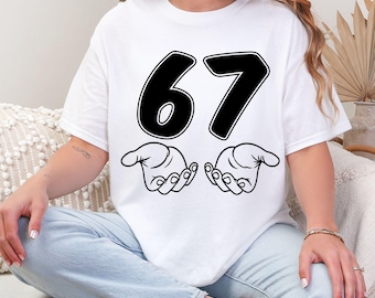 Camiseta con el meme del 67, camiseta con la mano del 67, camiseta con el 67, camiseta con el 67 de goteo, camiseta con el 67 seis siete, camiseta con el 67 de texto, camiseta con la energía del aura del 67, camiseta con la ilusión del 67 6 7