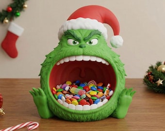 May include: A green, Grinch-themed candy dish with a red Santa hat. The dish is filled with colorful candies and has an open mouth design. Festive holiday decor.