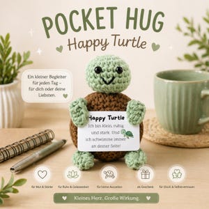 May include: A crocheted Happy Turtle with a green head and limbs, and a brown body. The turtle holds a card with text. The image includes the text "POCKET HUG Happy Turtle" and other text in German.