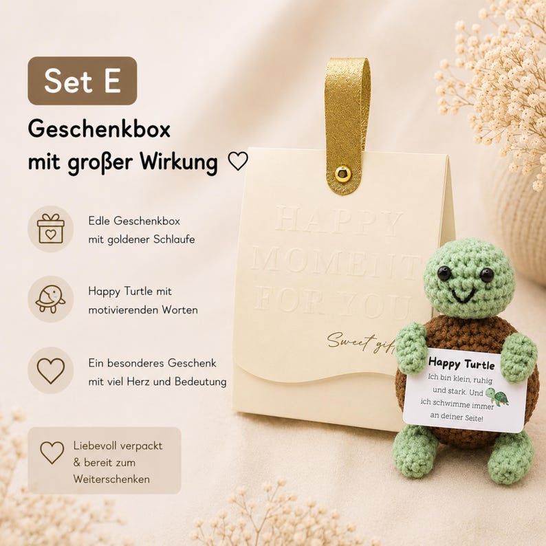 May include: A gift set featuring a cream-colored gift bag with a gold handle and the words "HAPPY MOMENT FOR YOU" embossed on the front. A crocheted green and brown turtle holds a card that reads "Happy Turtle".