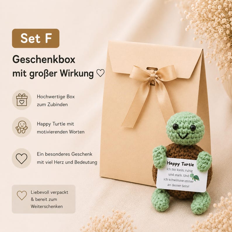 May include: A gift set featuring a tan paper gift bag with a satin ribbon bow, and a crocheted green and brown turtle holding a card. The card reads "Happy Turtle" with a motivational message. The set is designed for gifting.